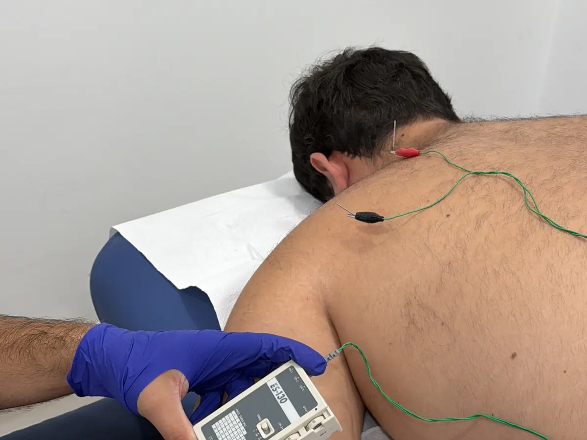 Fisioterapeuta tratando a un paciente en camilla en Posadas